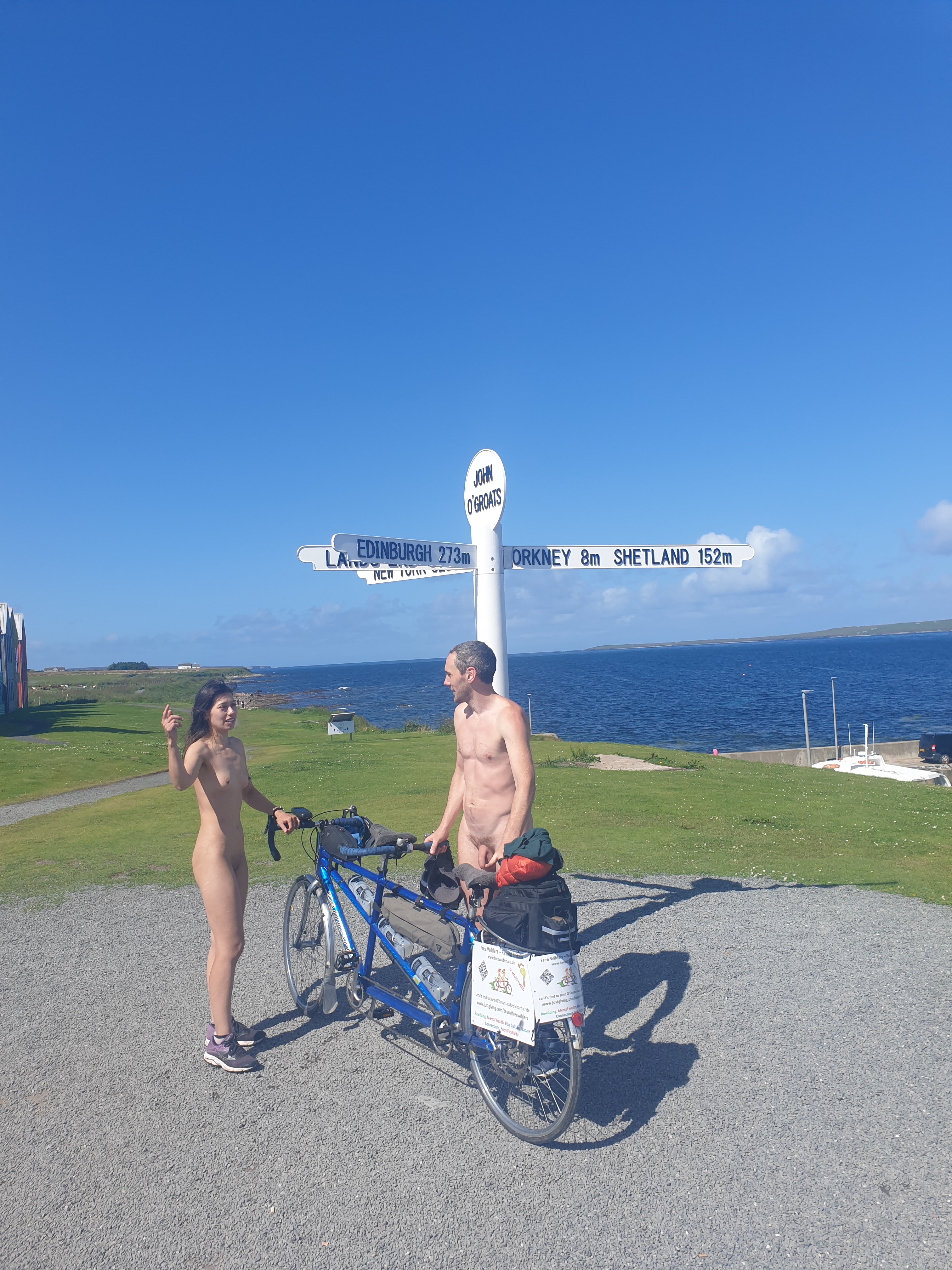 Neil and his female friend Hannah naked at John O'Groats, having just finished their 1,000 mile charity cycle from Lands' End